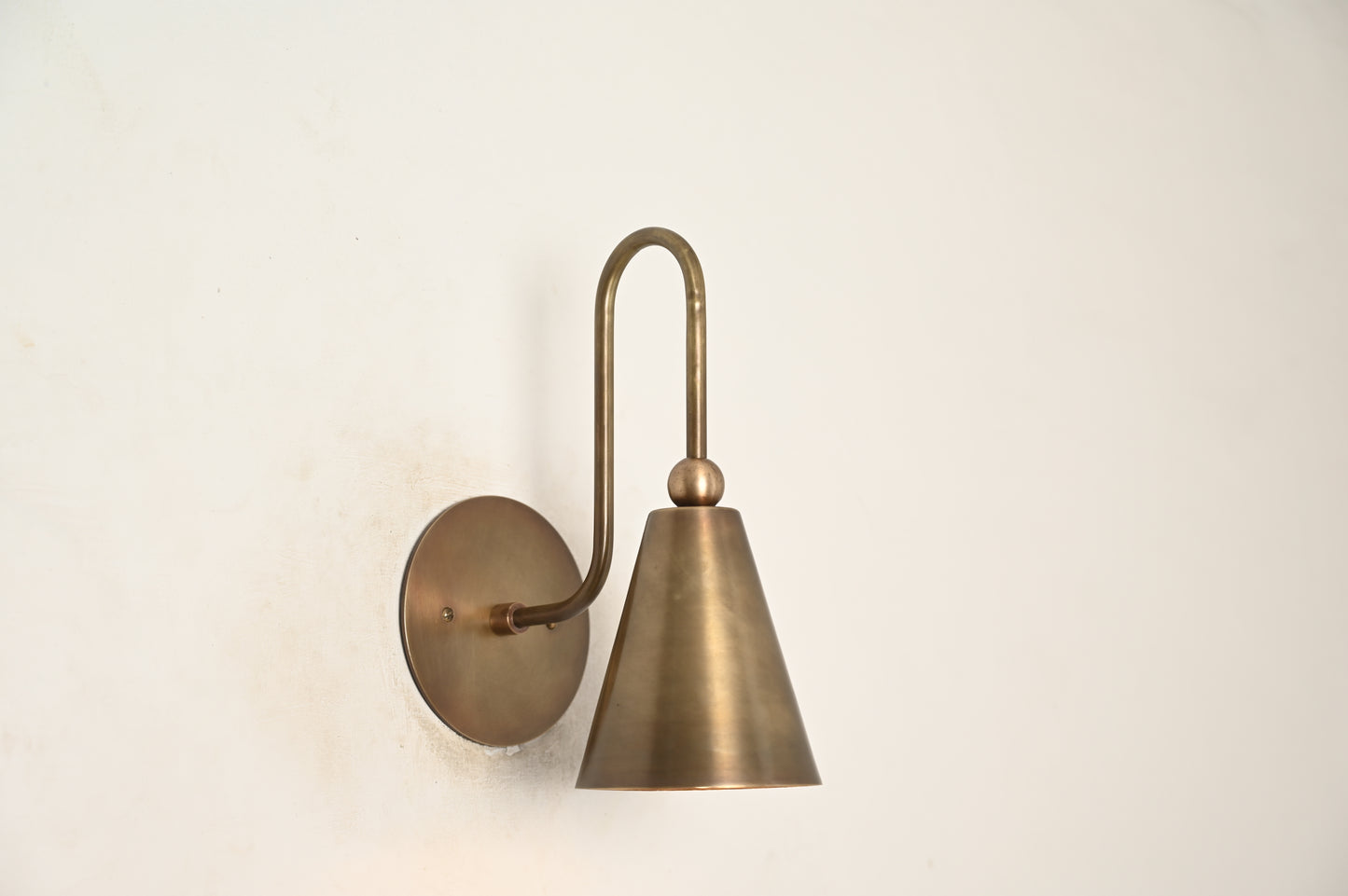 Mid-century modern wall sconces with raw brass finish and Sputnik design, adding style