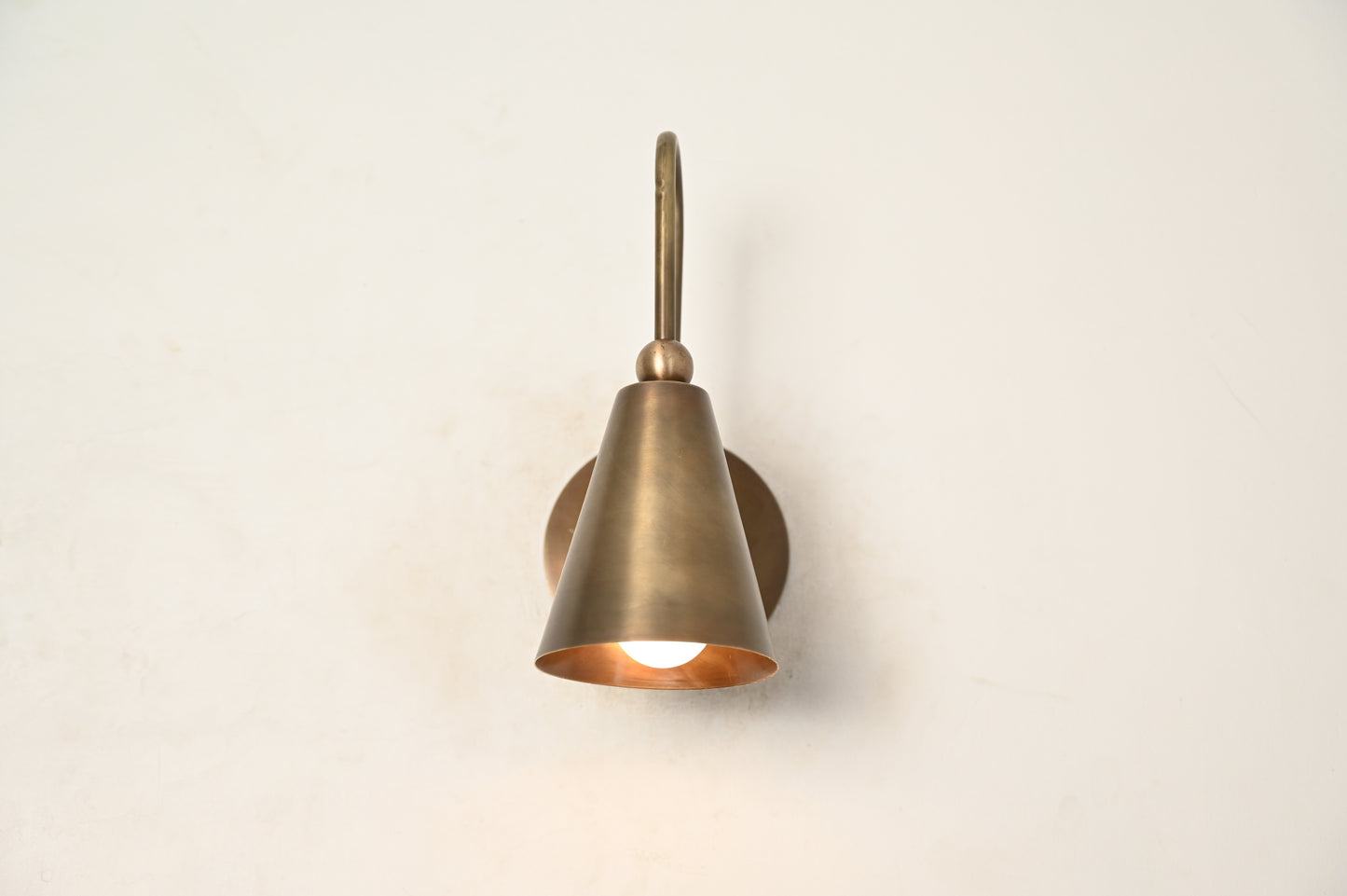 Mid-century modern wall sconces with raw brass finish and Sputnik design, adding style