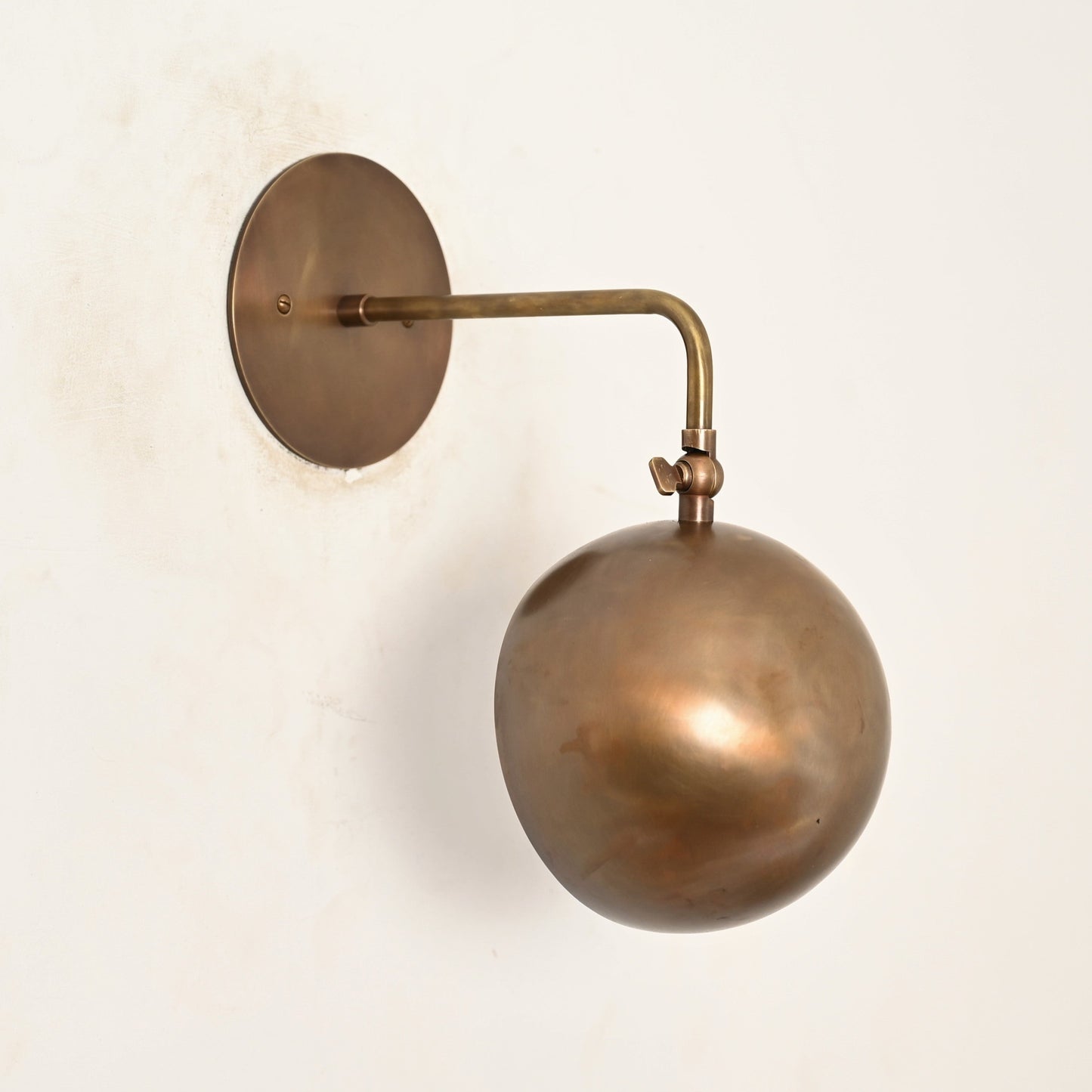 Illuminate your space with our 1-Light Mid-Century Wall Sconce in Raw Brass—elegant