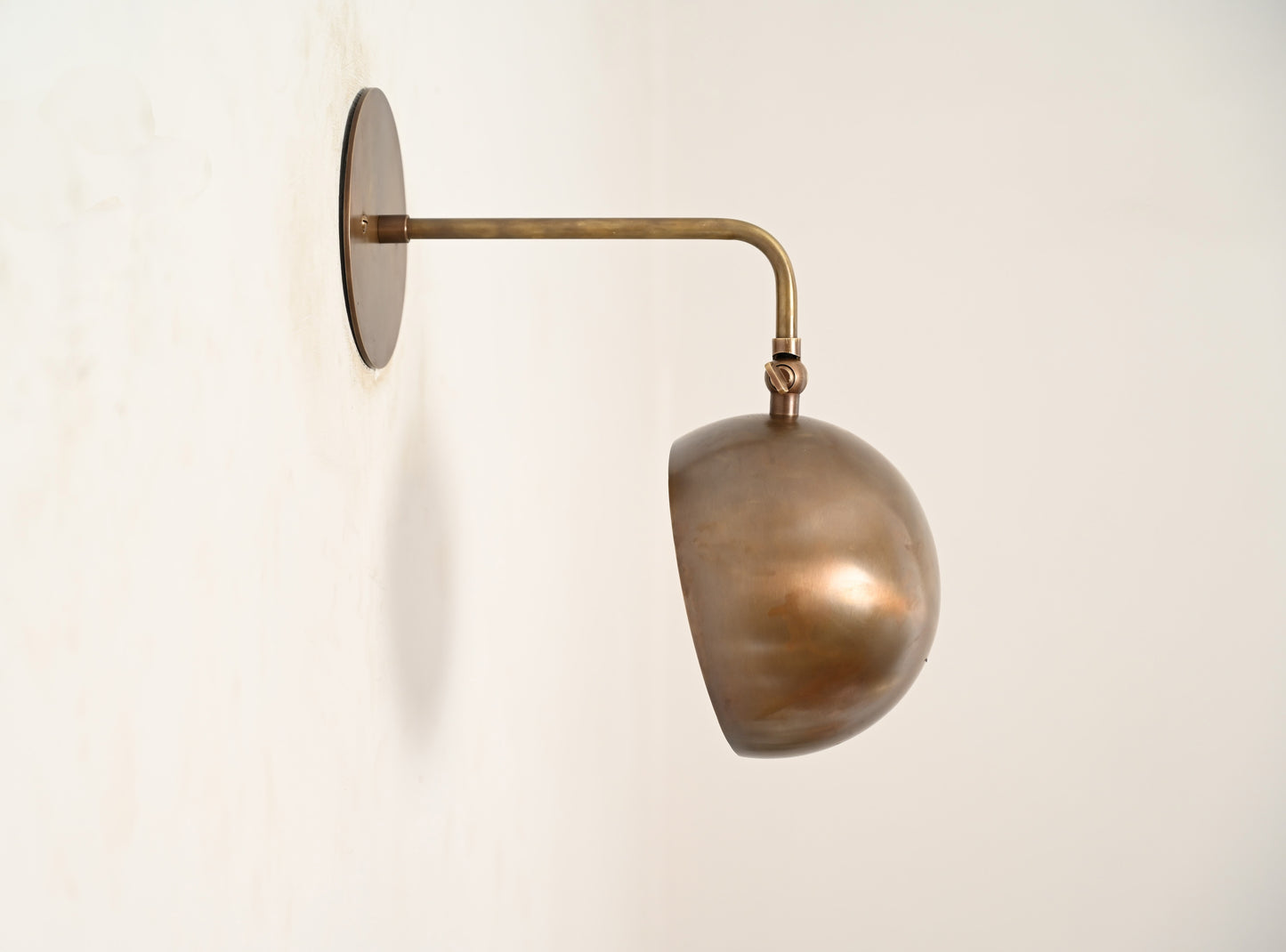 Illuminate your space with our 1-Light Mid-Century Wall Sconce in Raw Brass—elegant