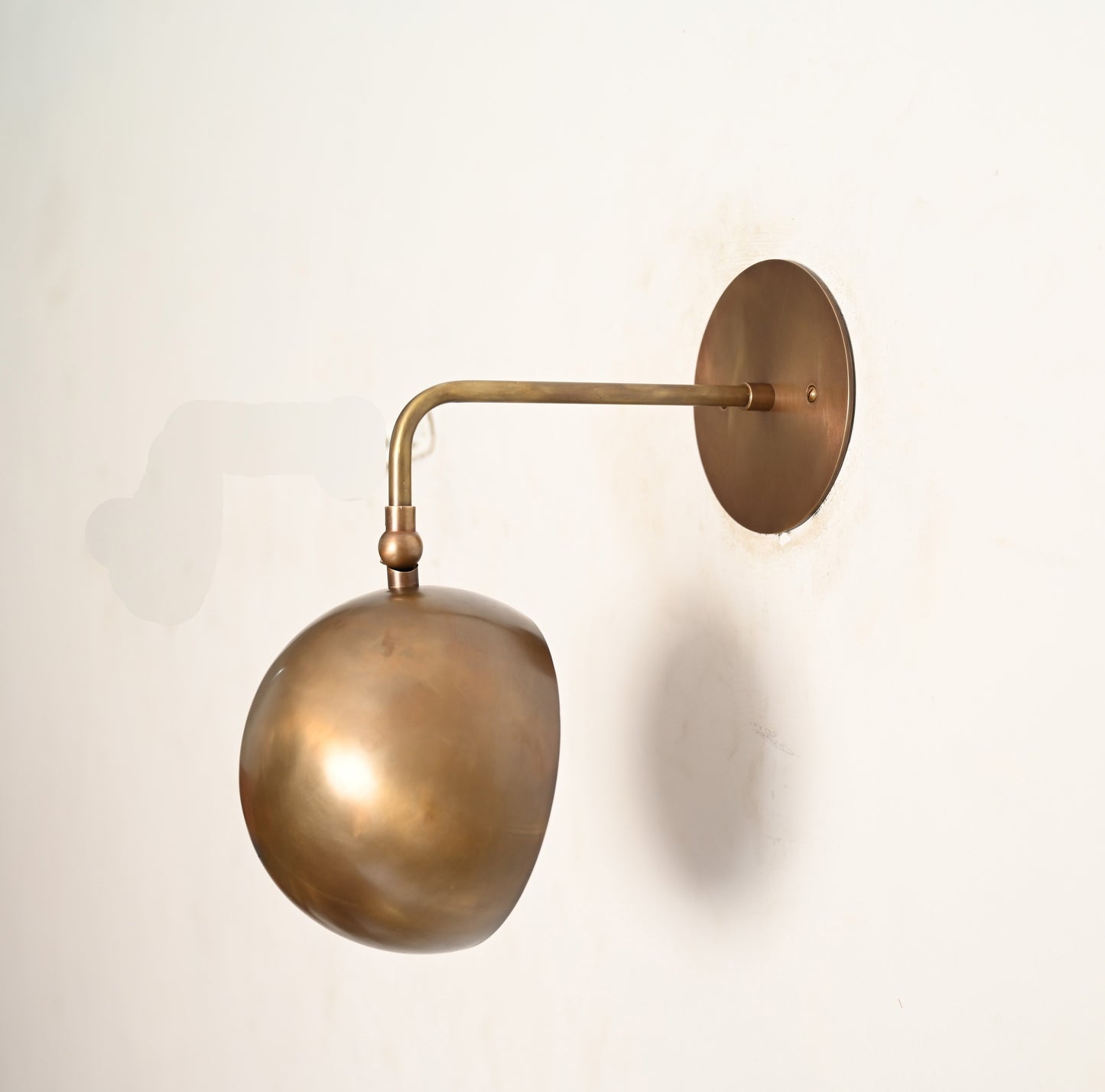 Illuminate your space with our 1-Light Mid-Century Wall Sconce in Raw Brass—elegant