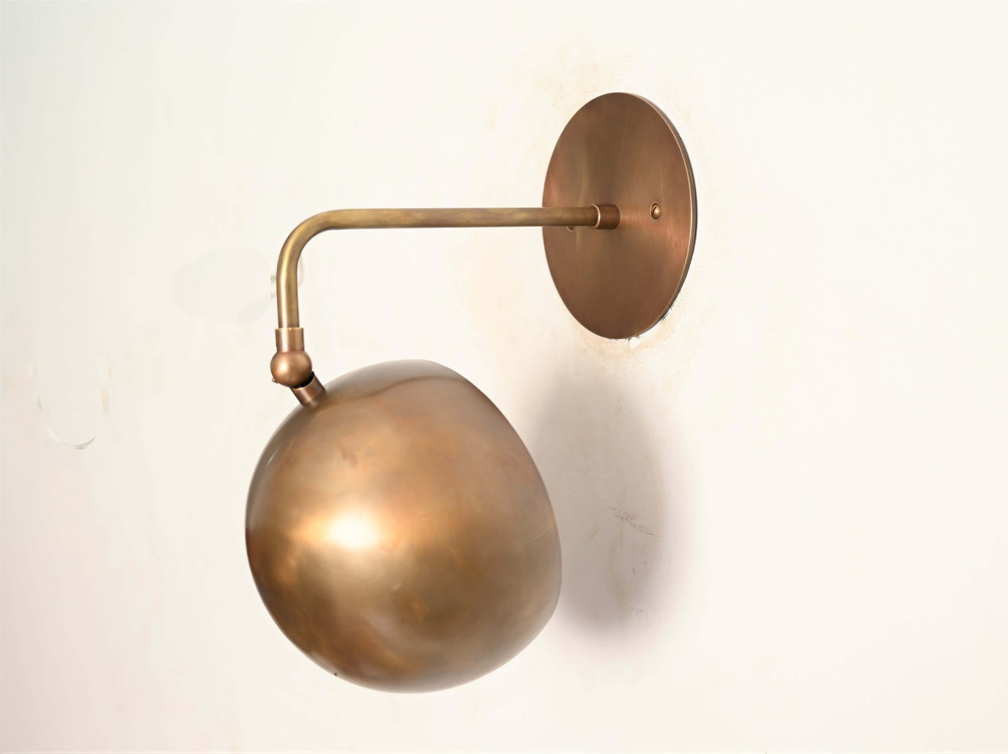 Illuminate your space with our 1-Light Mid-Century Wall Sconce in Raw Brass—elegant