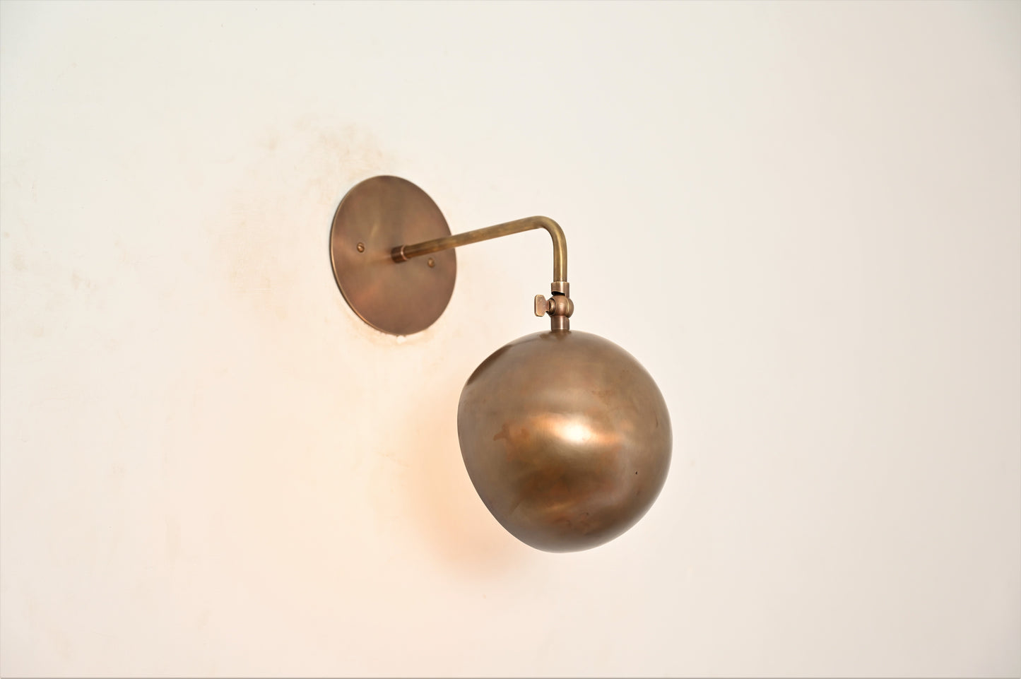 Illuminate your space with our 1-Light Mid-Century Wall Sconce in Raw Brass—elegant