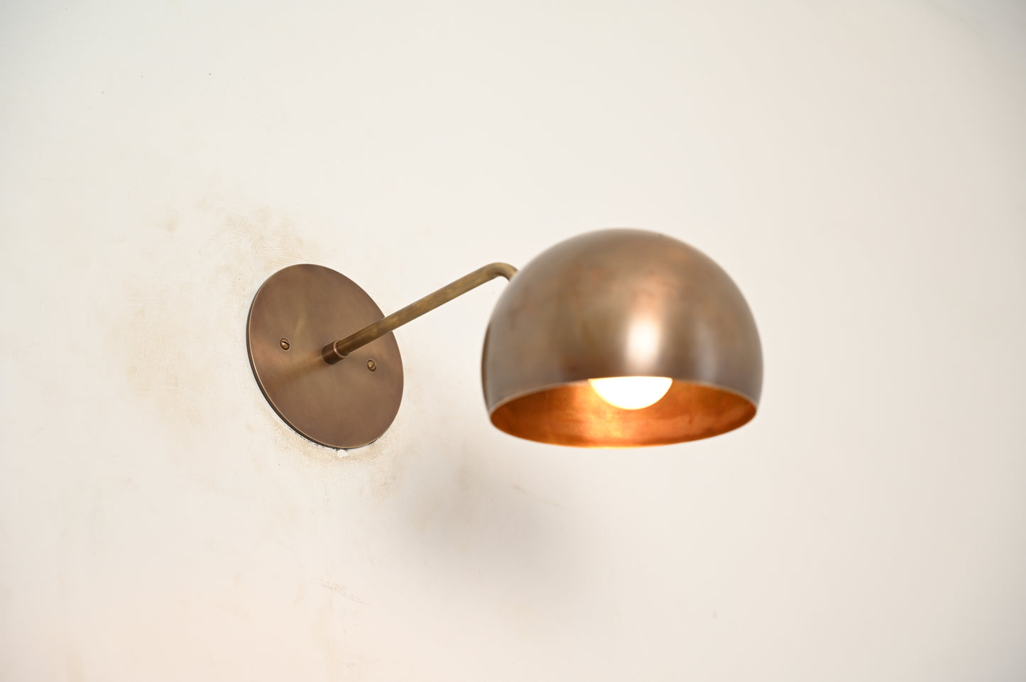 Illuminate your space with our 1-Light Mid-Century Wall Sconce in Raw Brass—elegant