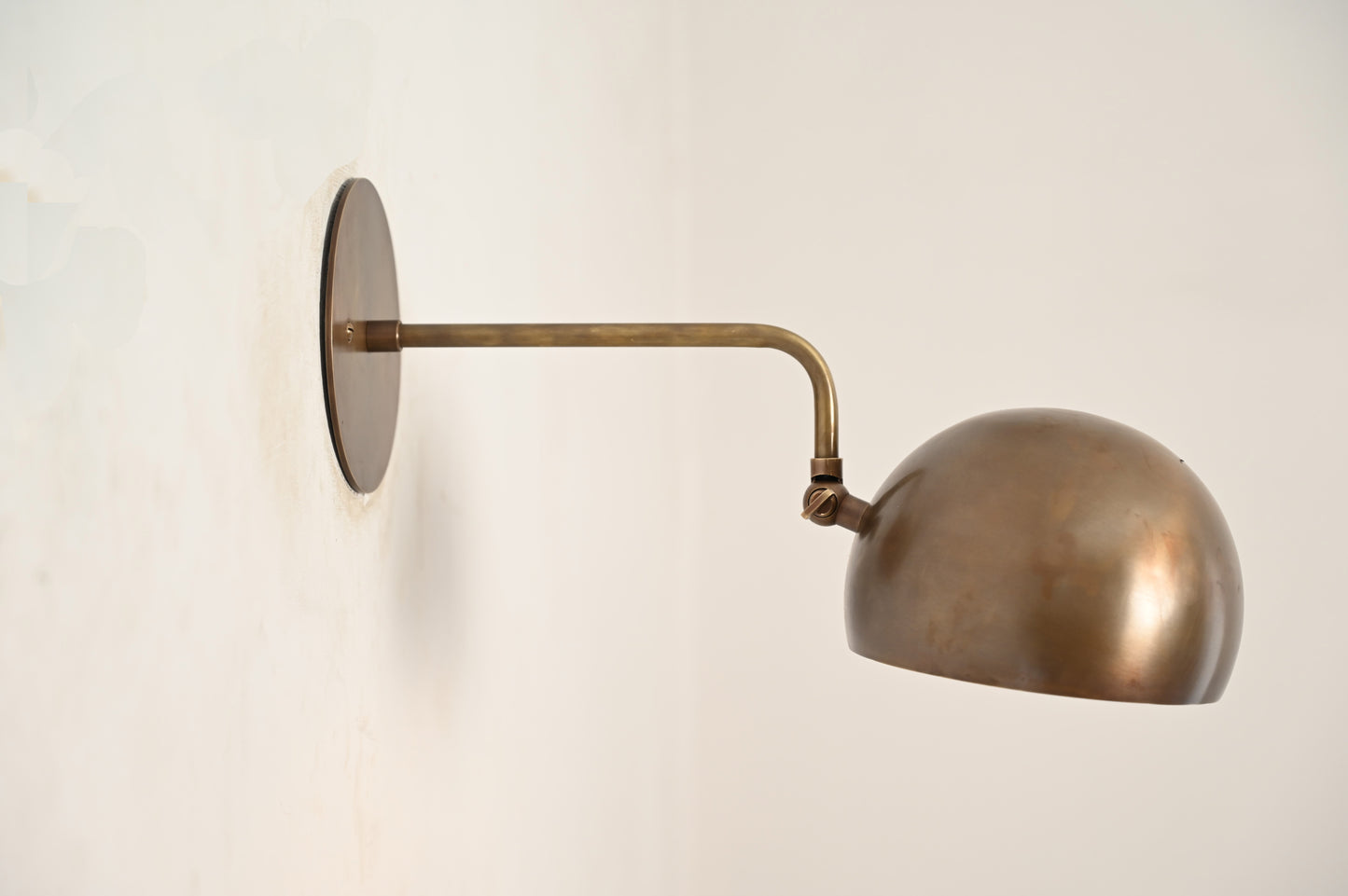 Illuminate your space with our 1-Light Mid-Century Wall Sconce in Raw Brass—elegant