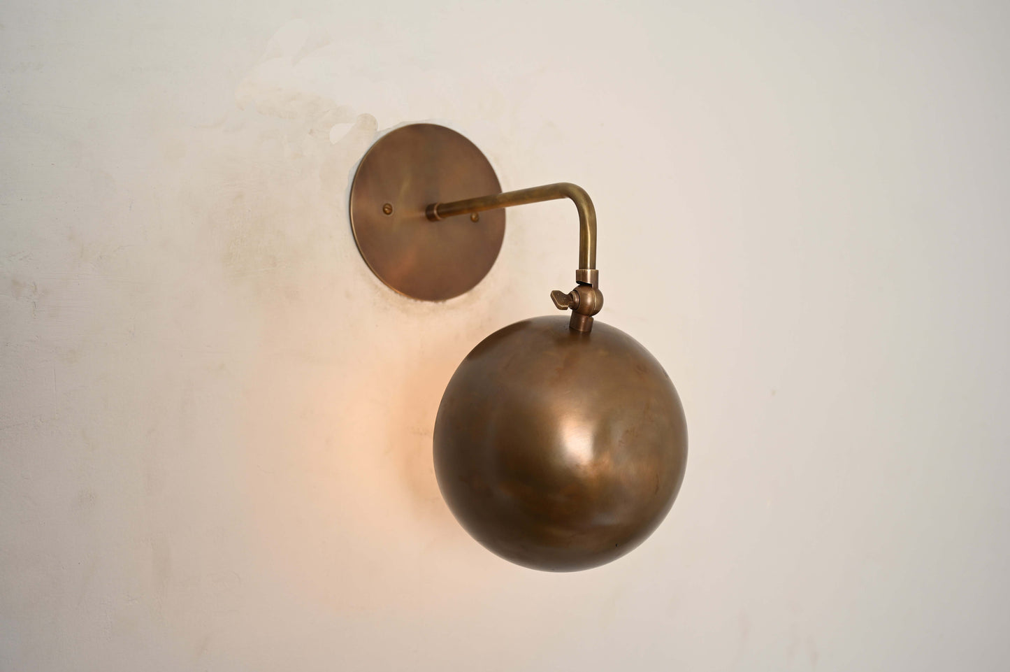 Illuminate your space with our 1-Light Mid-Century Wall Sconce in Raw Brass—elegant