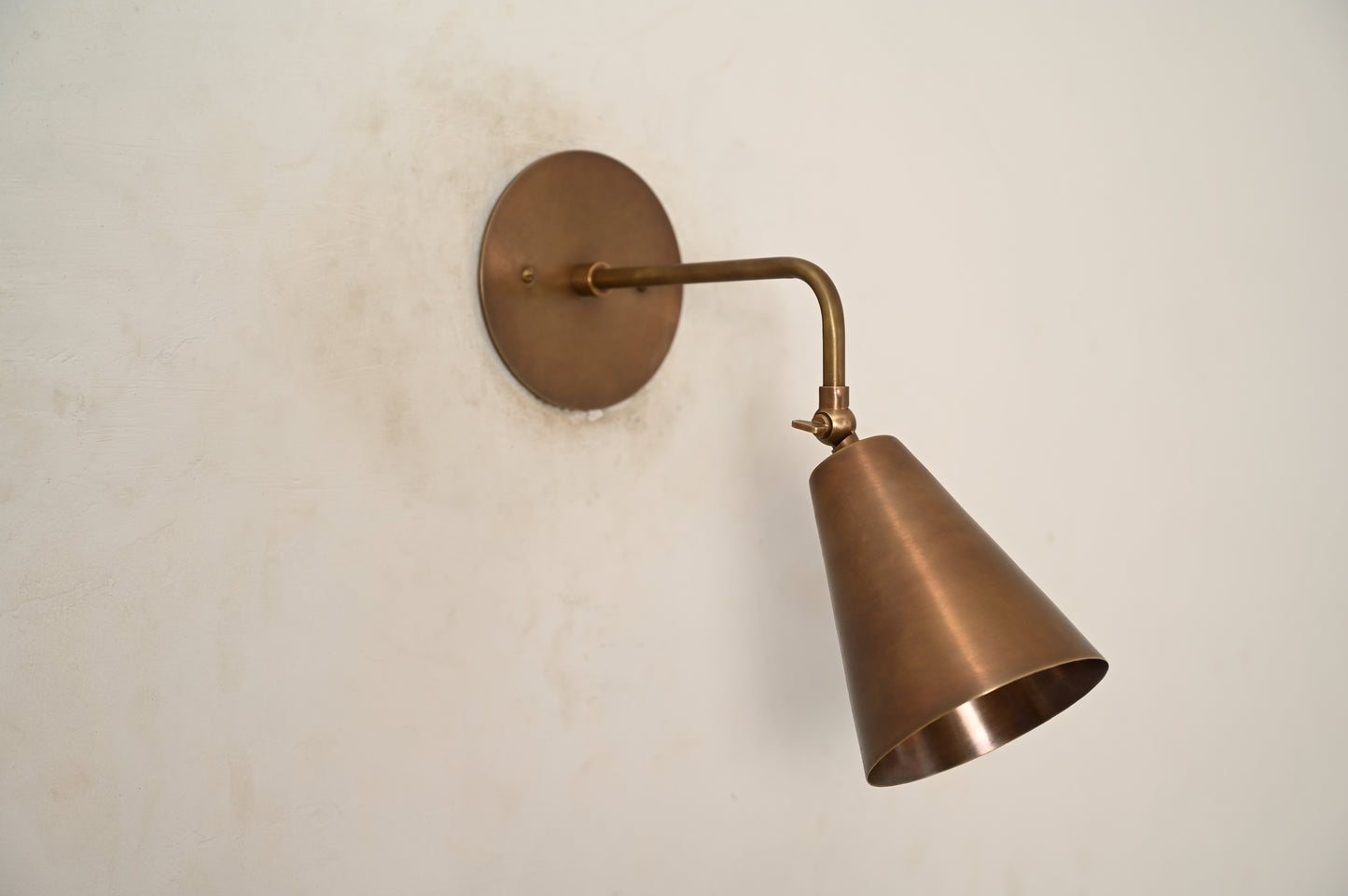 The Swivel Wall Lamp has an adjustable arm, blending style with functionality