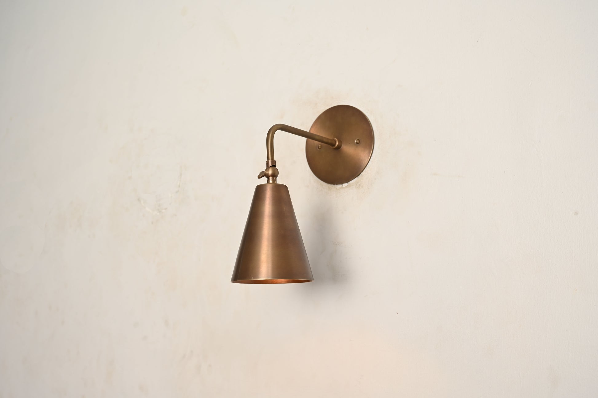 The Swivel Wall Lamp has an adjustable arm, blending style with functionality