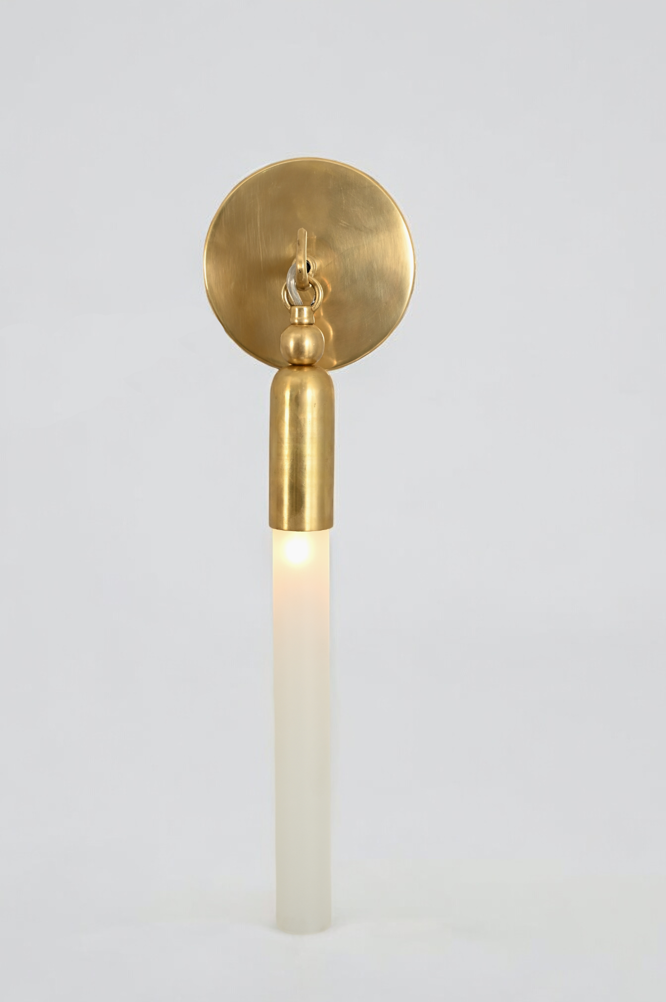 Illuminate your space with the TASSEL 1 Sconce—sleek glass tube and brass accents