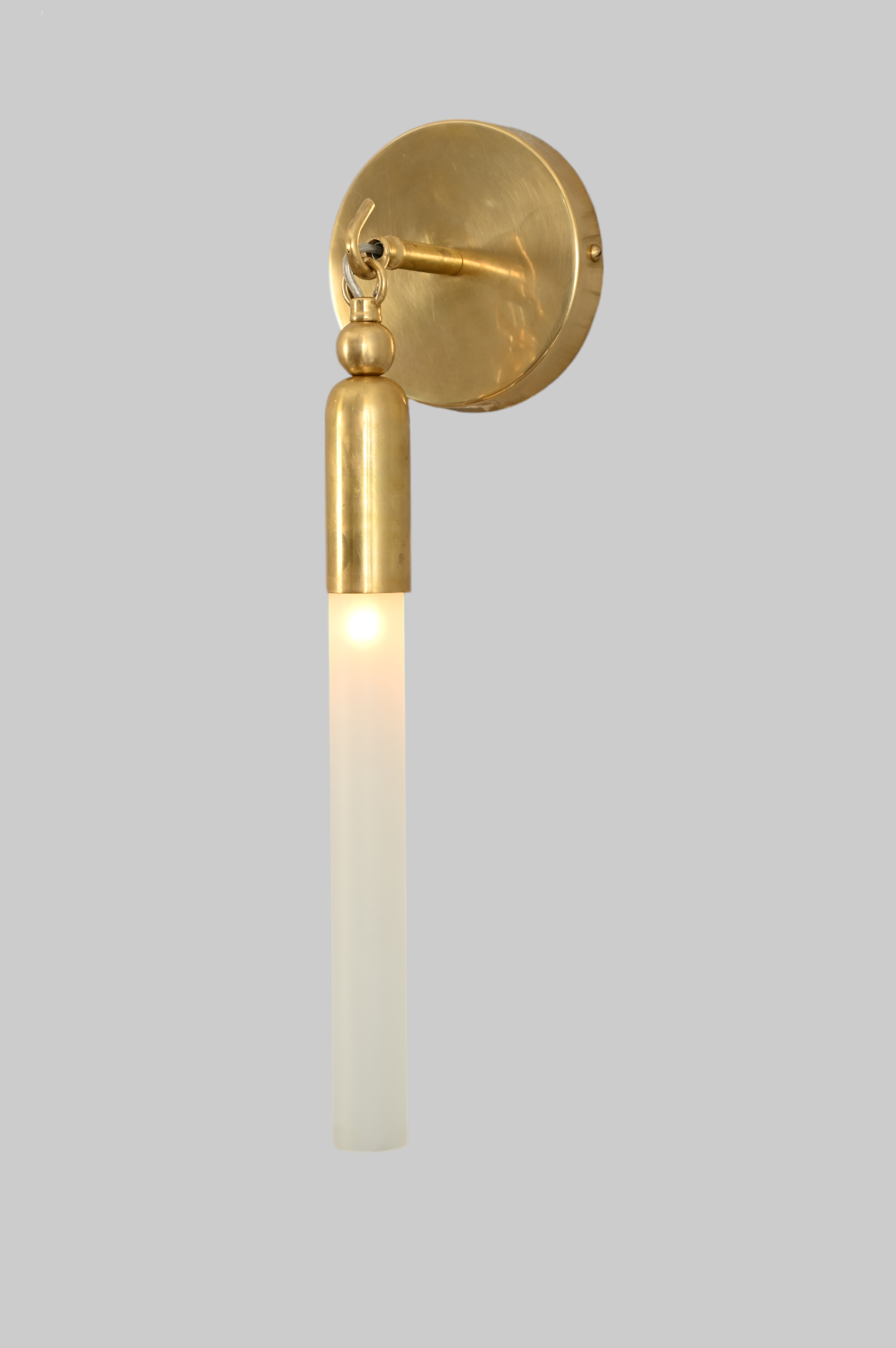 Illuminate your space with the TASSEL 1 Sconce—sleek glass tube and brass accents