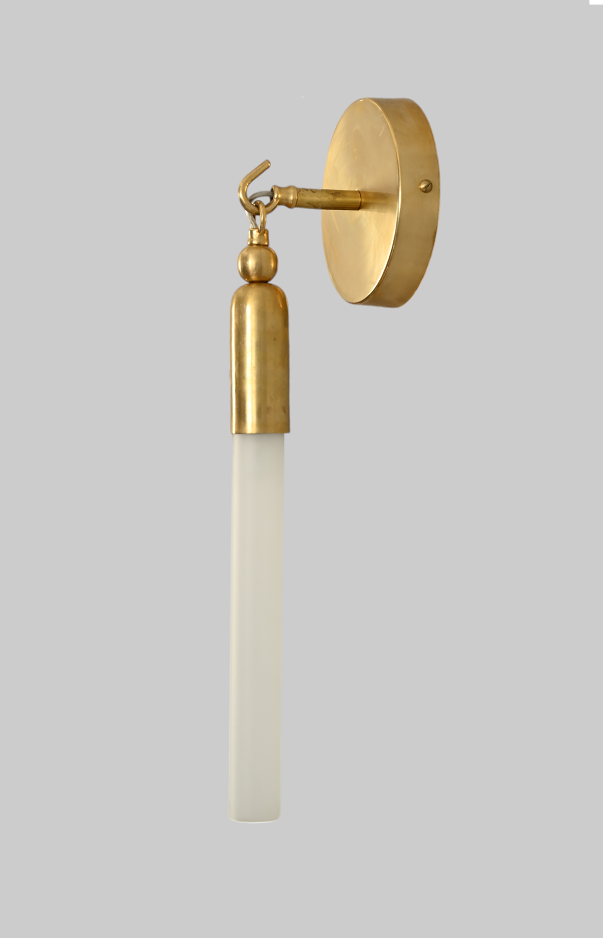 Illuminate your space with the TASSEL 1 Sconce—sleek glass tube and brass accents