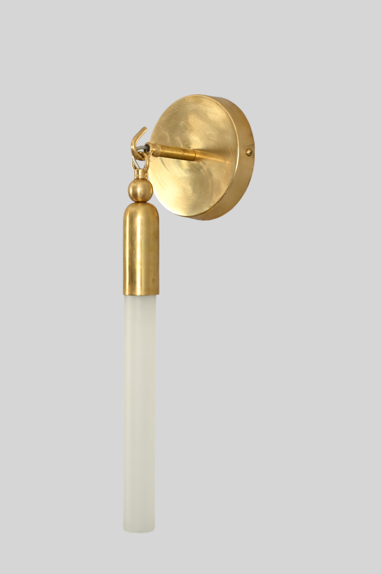 Illuminate your space with the TASSEL 1 Sconce—sleek glass tube and brass accents