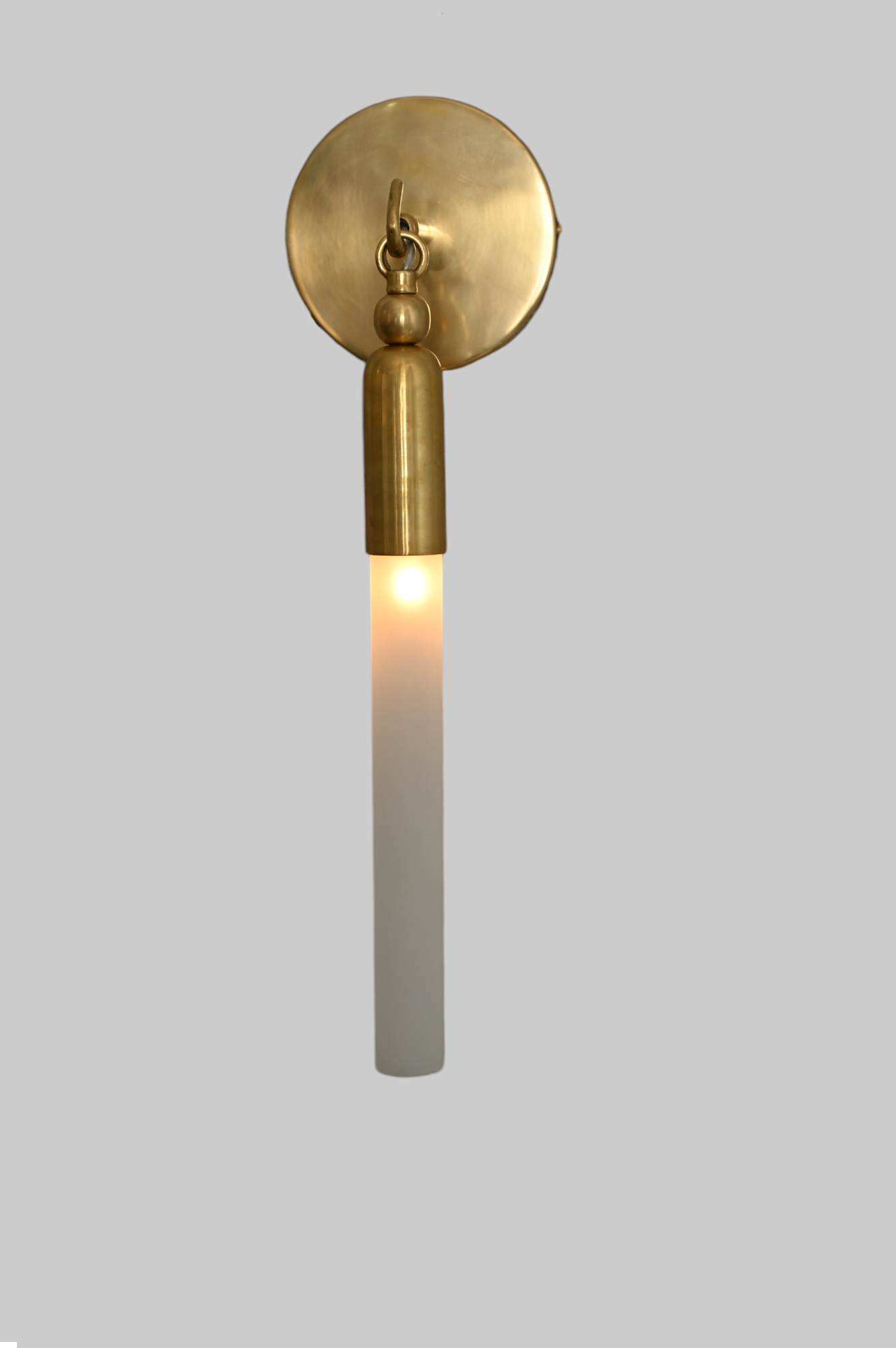 Illuminate your space with the TASSEL 1 Sconce—sleek glass tube and brass accents