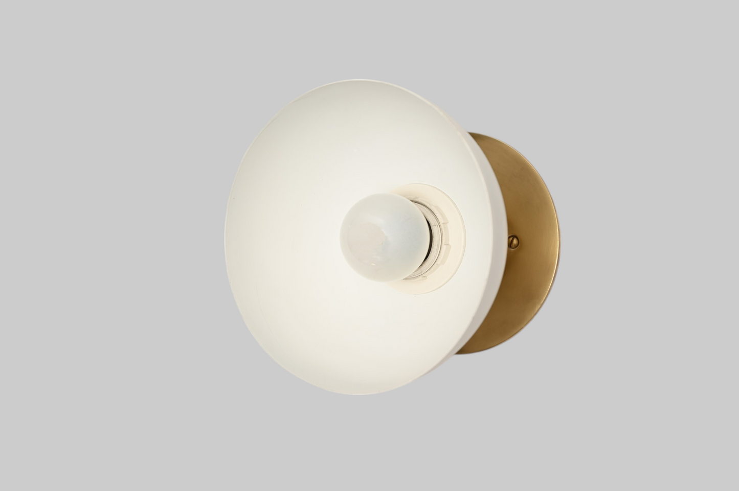 Modern brass wall light, ideal for vanities or hallways, with sleek, warm illumination