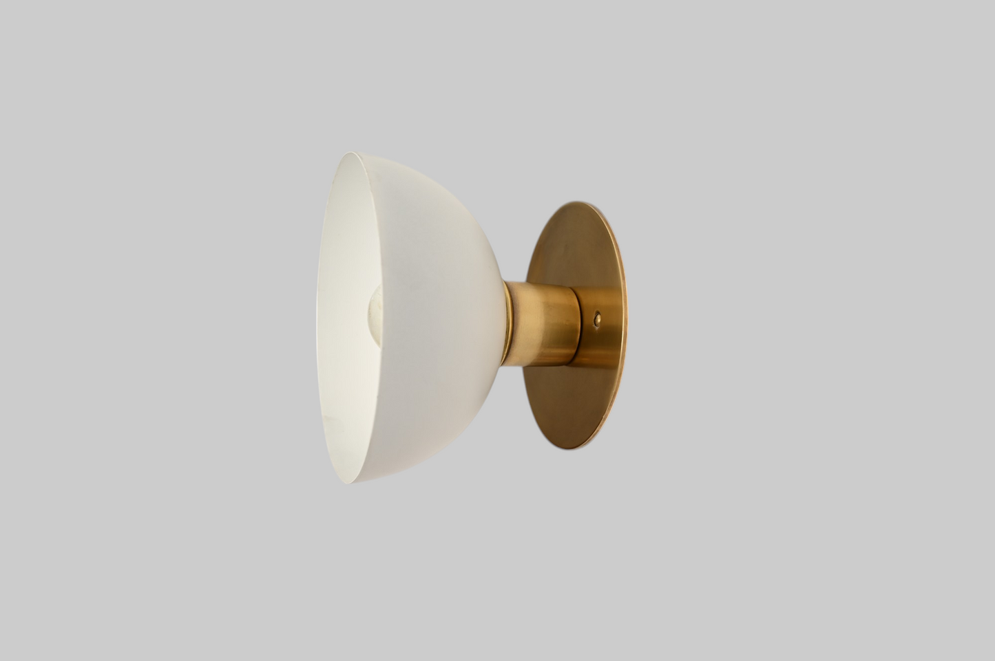 Modern brass wall light, ideal for vanities or hallways, with sleek, warm illumination