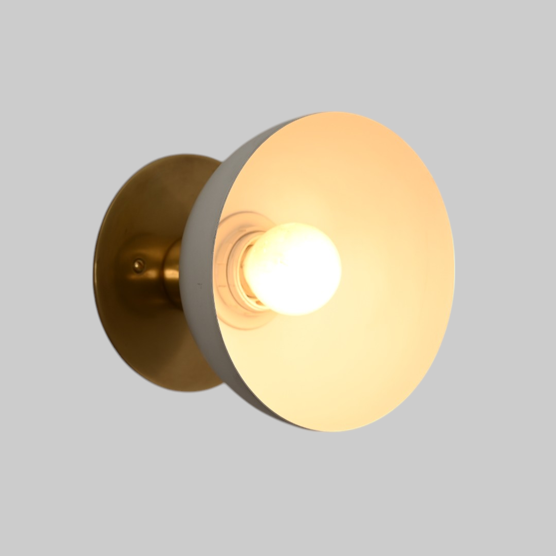 Modern brass wall light, ideal for vanities or hallways, with sleek, warm illumination