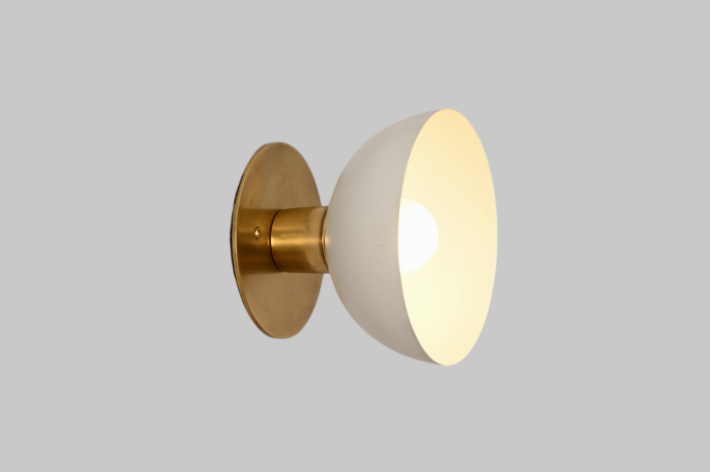 Modern brass wall light, ideal for vanities or hallways, with sleek, warm illumination