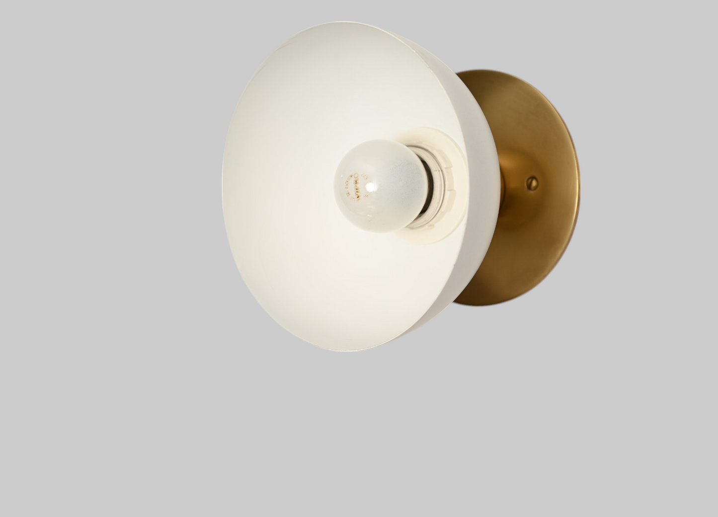 Modern brass wall light, ideal for vanities or hallways, with sleek, warm illumination