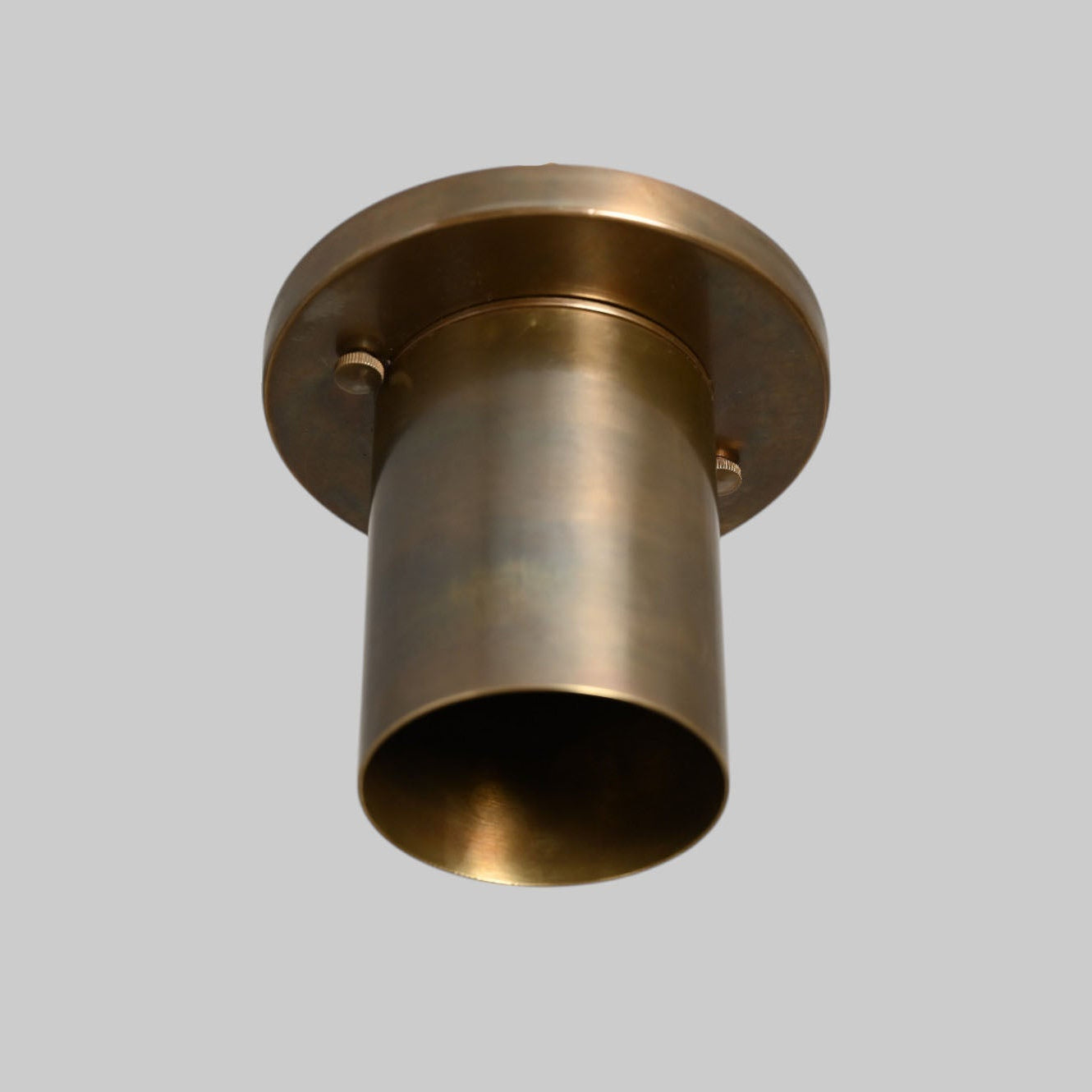 Sleek antique brass downlight adds warm, modern elegance to any space
