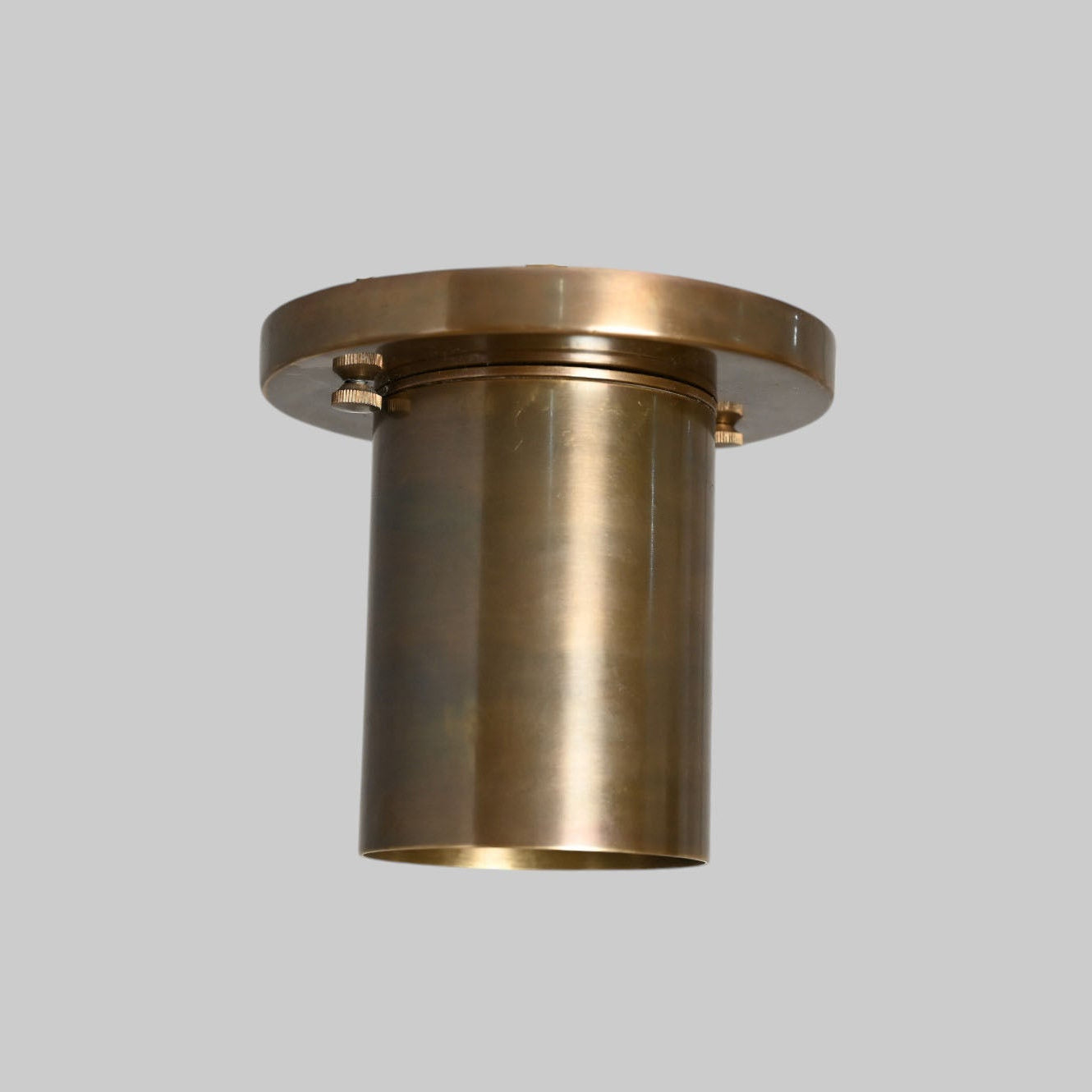 Sleek antique brass downlight adds warm, modern elegance to any space