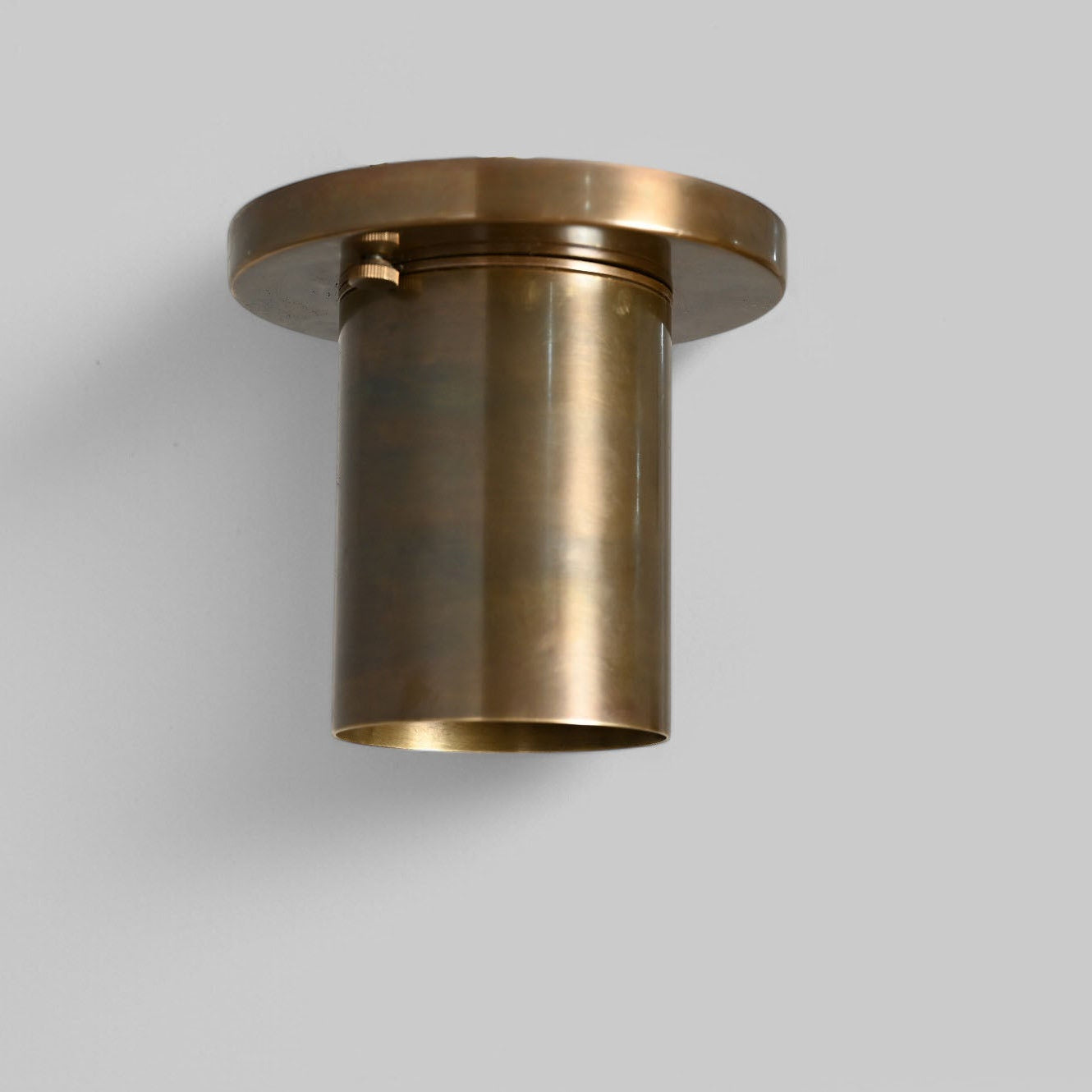 Sleek antique brass downlight adds warm, modern elegance to any space