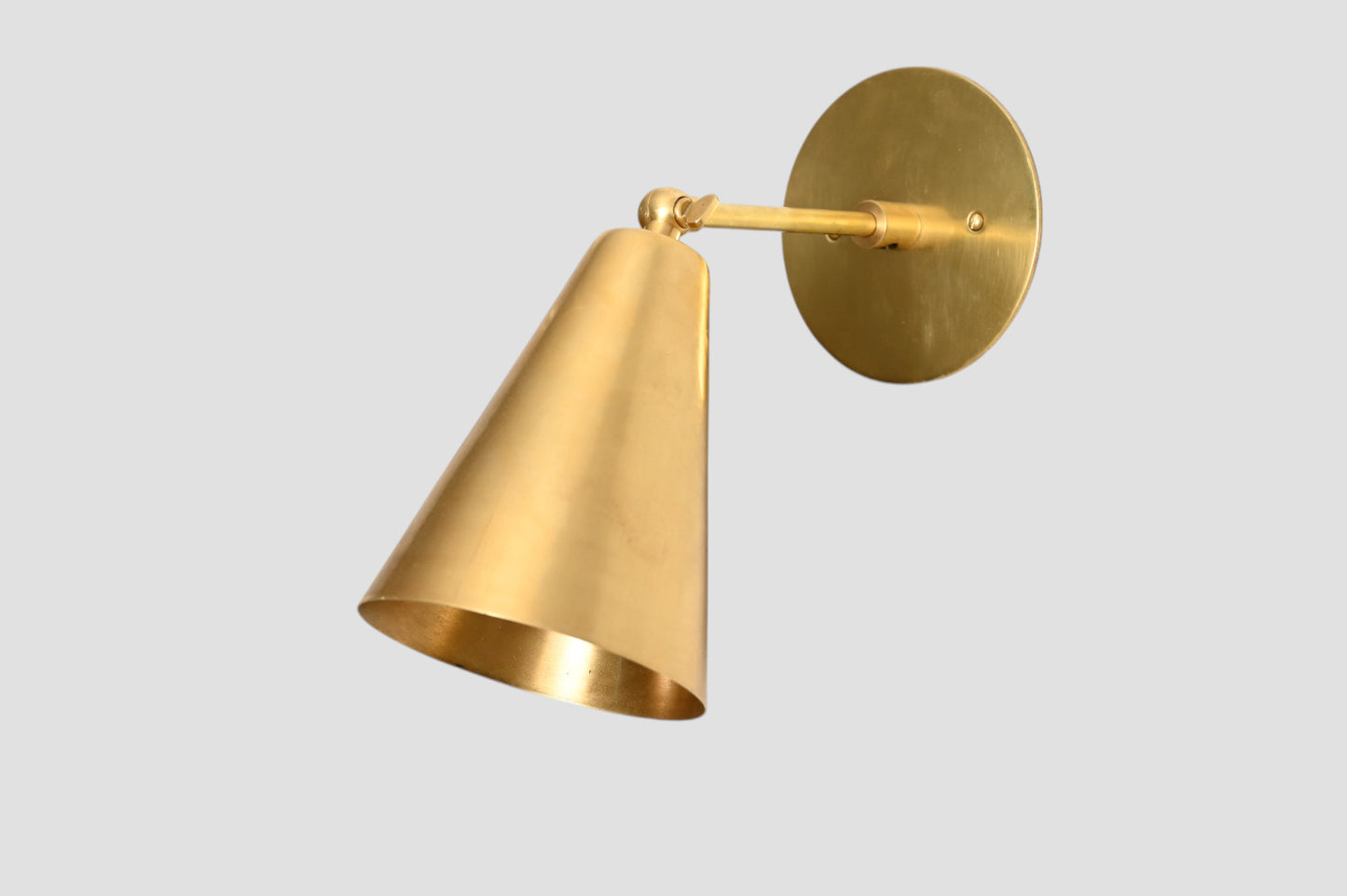 Mid-Century Modern Cone Wall Light: Raw brass, radiant glow, sleek timeless design