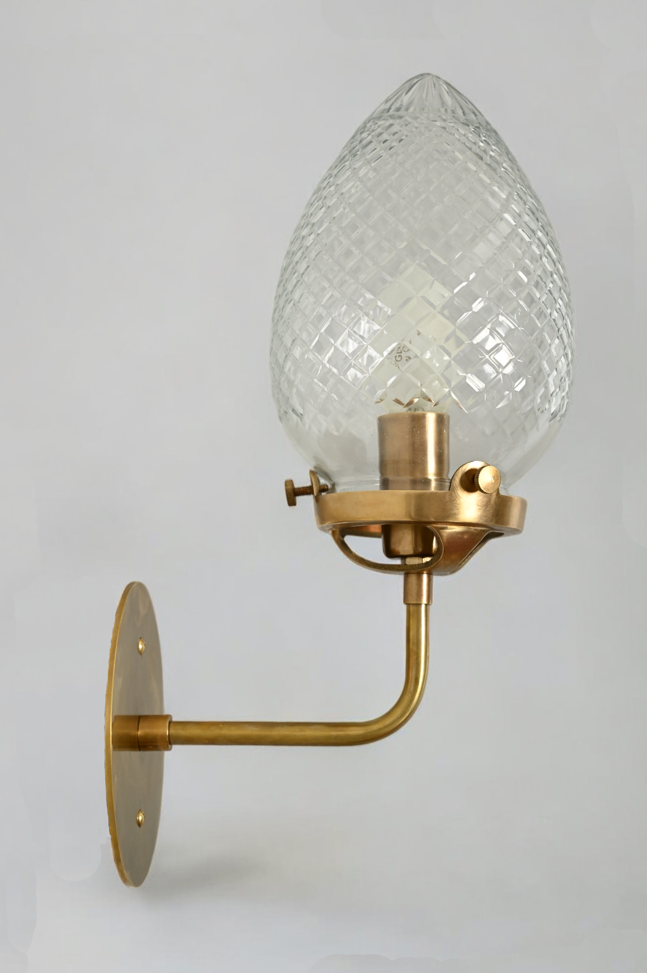 Brighten your space with the Conical Globes Wall Sconce, featuring raw brass charm