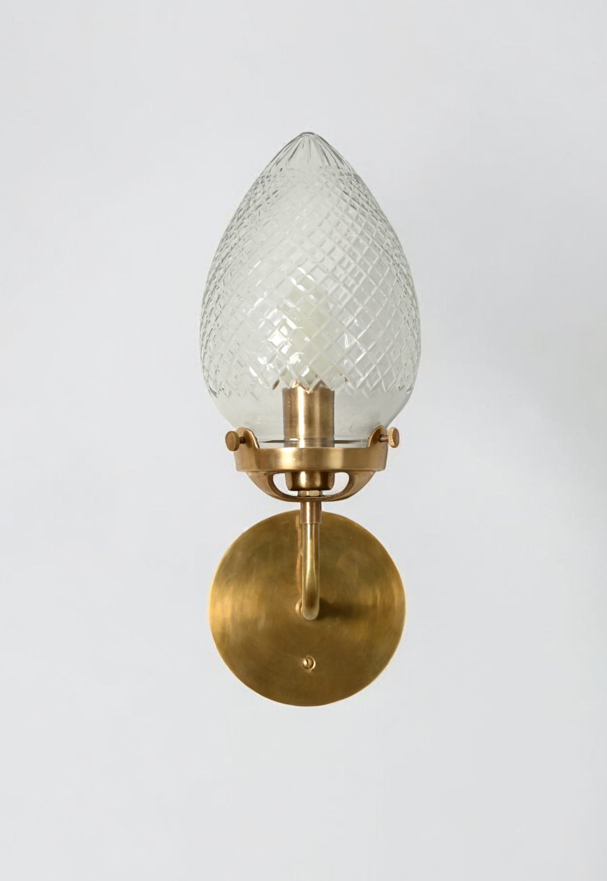 Brighten your space with the Conical Globes Wall Sconce, featuring raw brass charm