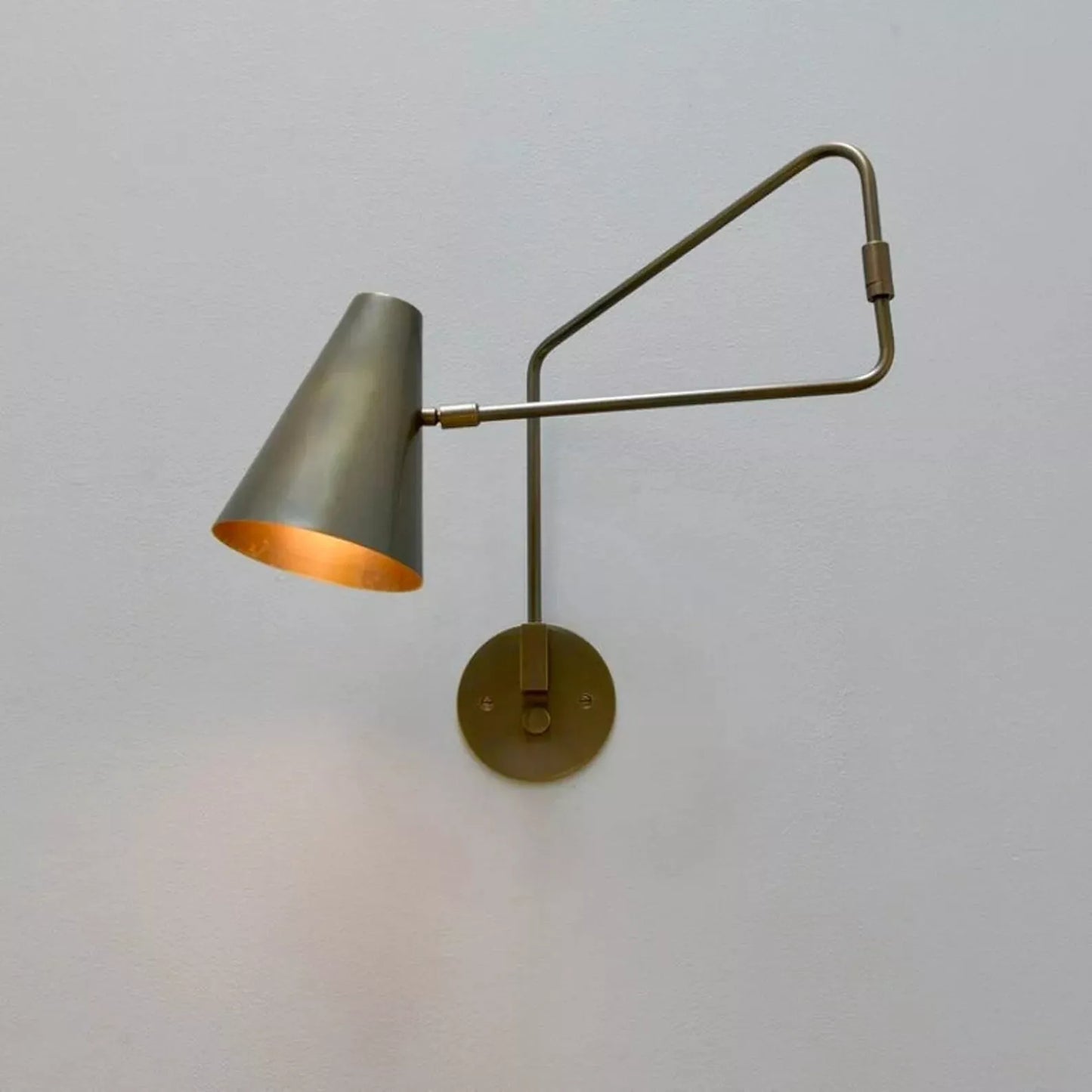 Moveable wall lamp offers flexible lighting with adjustable angle and direction.